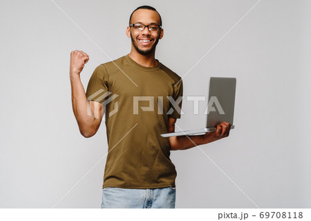 A young african american man working with a laptop pc A young african american man working with a laptop pc 69708118