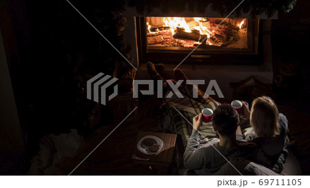 Romantic couple drinks ay by the fireplace, top view 69711105