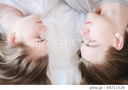 A young couple in love a man and a woman lie and look at each other with loving glances. Generation x young family concept 69711526