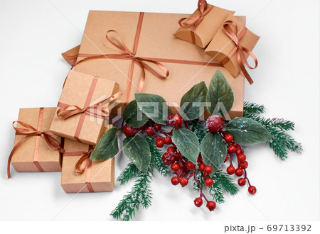 A Christmas gift. Box with brown satin ribbon on a white background. A Christmas gift. Box with brown satin ribbon on a white background. 69713392