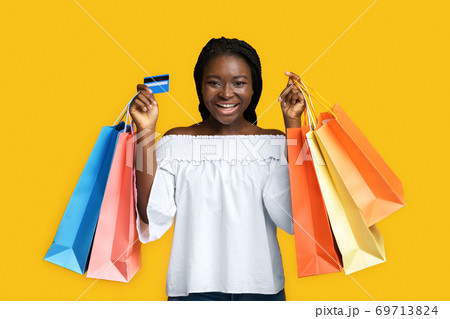 Big Shopping. Joyful Black Woman Posing With Shopper Bags And Credit Card 69713824