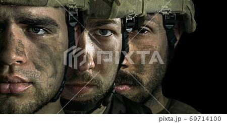 Close up portrait of young male soldiers. Men in military uniform on the war, flyer 69714100