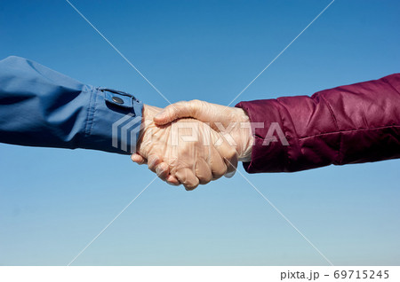 Handshake in medical gloves.  69715245