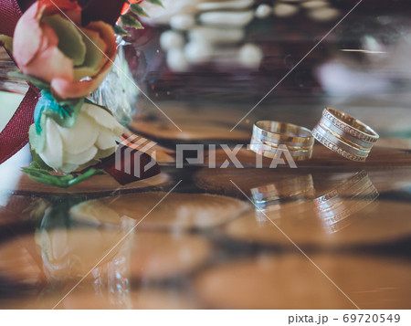 Golden wedding rings in decorative champagne glass 69720549