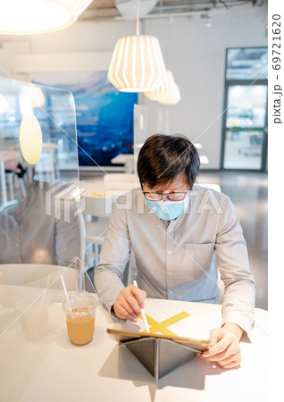 Asian man working in cafe with social distancing 69721620