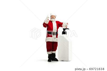 Santa Claus with the huge antiseptics against COVID like Christmas gift isolated on white background 69721638
