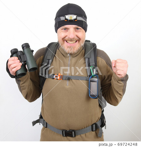 happy tourist traveler with binoculars in hand on a white background happy tourist traveler with binoculars in hand on a white background 69724248