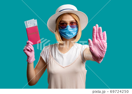 stop gesture travel ban woman mask passport 69724250