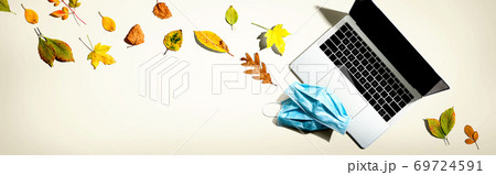 Laptop computer with masks in autumn Laptop computer with masks in autumn 69724591