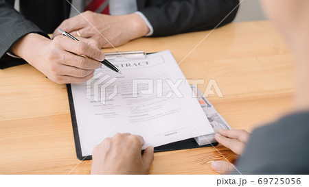 Businessman giving money while making deal to agreement a real estate contract and financial corporate.Bribery and corruption concept 69725056