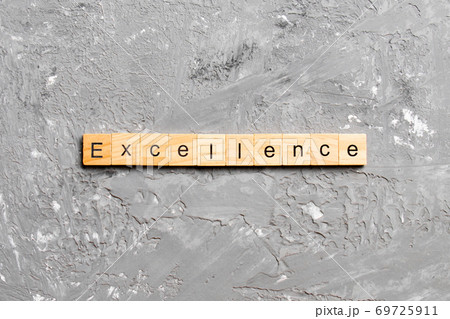 Excellence word written on wood block. Excellence text on cement table for your desing, concept 69725911