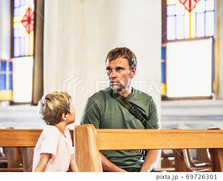Christian dad tells his son Bible stories about Jesus sitting in kirk. Faith, religious education, modern church, father day, fatherly responsibilities, father influence on formation of son worldview Christian dad tells his son Bible stories about Jesus sitting in kirk. Faith, religious education, modern church, father day, fatherly responsibilities, father influence on formation of son worldview 69726301