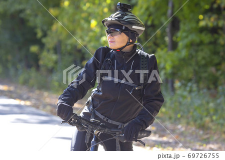 Beautiful women cyclist rides a bicycle. Healthy lifestyle and sport. Leisure and hobbies 69726755