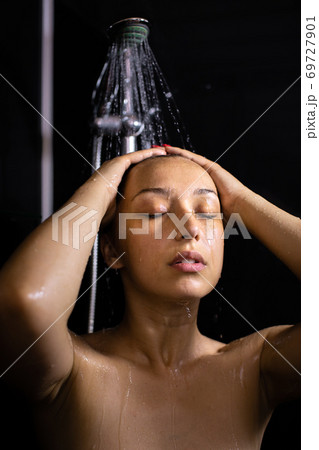 Sensual portrait of young beautiful woman taking shower, relaxation tips concept 69727901