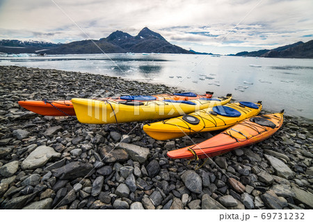 Double kayaks parked on the pier on scenic mountain ocean bay in Valdez, Alaska 69731232