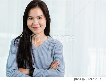 Asian beautiful woman smiling face long hair stand crossed arm 69734346