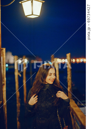 female tourist walking around and exploring venice 69734427
