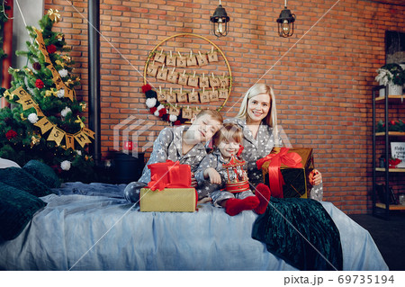 Family sitting on a bed Family sitting on a bed 69735194