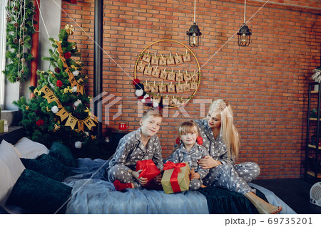 Family sitting on a bed Family sitting on a bed 69735201