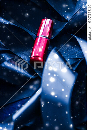 Red lipstick on blue silk and shiny glitter background, luxury make-up and beauty cosmetic 69735310