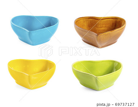 colorful handmade ceramic cups isolated on white background. 69737127