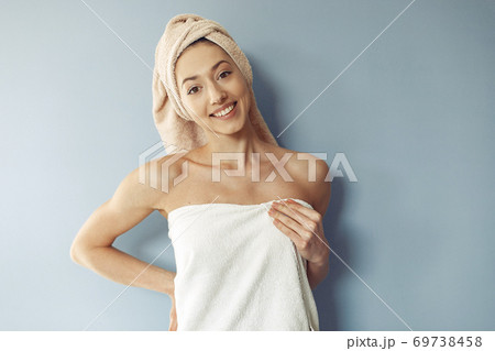 Beautiful girl standing in a studio in a towel 69738458