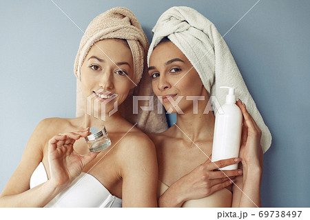 Beautiful girls standing in a studio with cream Beautiful girls standing in a studio with cream 69738497