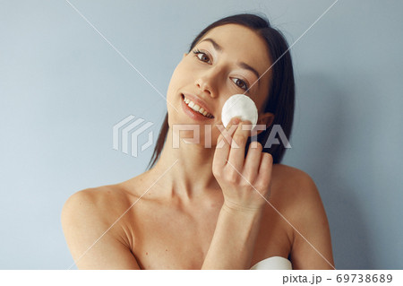 Beautiful girl standing in a studio with wadded disk Beautiful girl standing in a studio with wadded disk 69738689