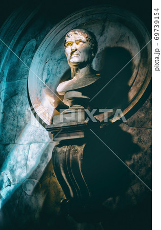 half-length statue portrait vertical background in the dark with sunray filter through the shadows 69739154