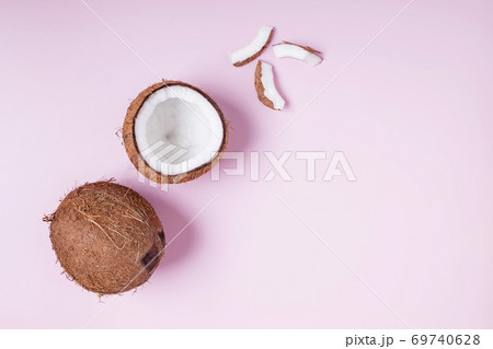Coconuts on pink background, top view. 69740628
