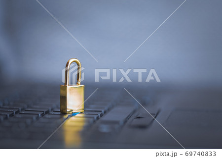 Background image of golden metal lock on keyboard, computer security 69740833