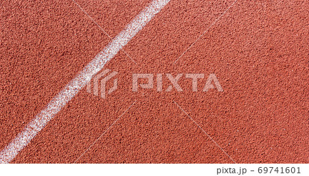 White painted line on tartan ground track in a athleticism and sports field. White painted line on tartan ground track in a athleticism and sports field. 69741601