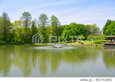 池と噴水がある公園の風景の写真素材