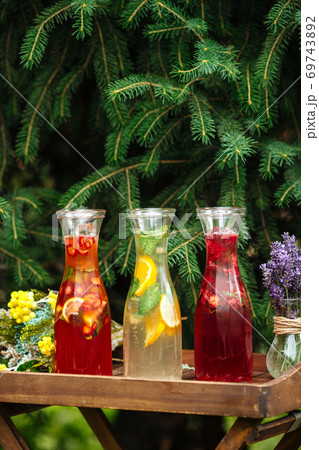 Side view on three fruit and berry lemonades Side view on three fruit and berry lemonades 69743892