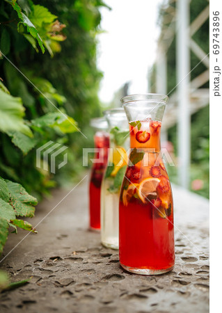 Side view on three fruit and berry lemonades Side view on three fruit and berry lemonades 69743896