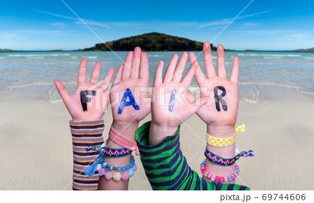 Children Hands Building Word Fair, Ocean Background 69744606