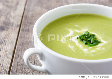 zucchini soup in bowl on wooden table.Copy space	 69744906