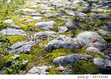 Ancient footpath from block stones from medieval age, texture stones, background of old stones. Old pavement. 69745086