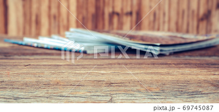 View of pile of different and overlayed magazines on wooden table. Background textures concept. 69745087