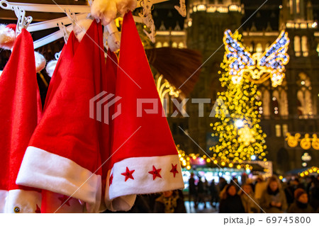 Santa Claus hats hangs on shop at The traditional Christmas market, Austria 69745800
