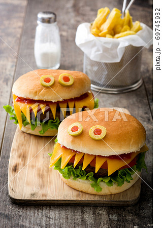 Halloween burger monsters on wooden table の写真素材 [69745932