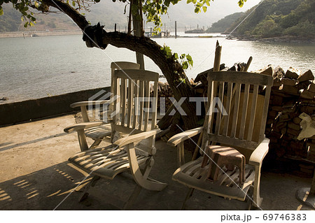 2 Dec 2007 a broke Wooden chairs at sunset on beach 69746383