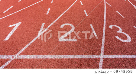 White painted lines and numbers on a running track in a athleticism and sports field.  69748959