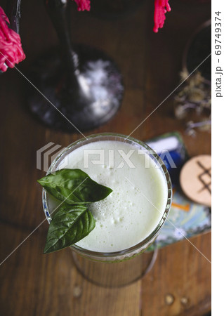 Fresh basil sour cocktail among red lights in dark style Fresh basil sour cocktail among red lights in dark style 69749374