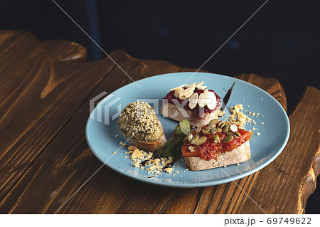 Three different vegetarian bruschetta served at the restaurant Three different vegetarian bruschetta served at the restaurant 69749622