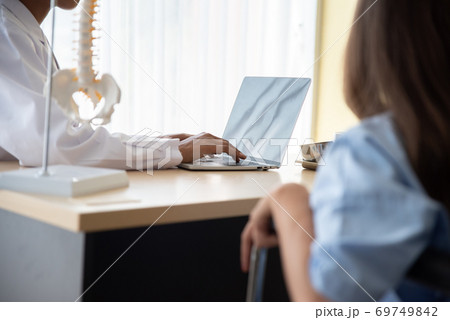 Doctor And Patient Discussing While Sitting At Hospital 69749842