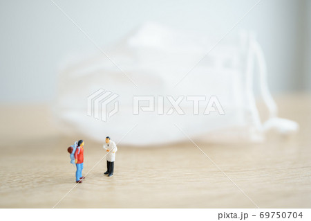 Miniature people traveler and doctor Check the tourists' bodies before entering the country  69750704