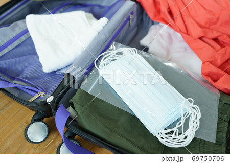 New normal packing clothes and Face mask into travel luggage  69750706