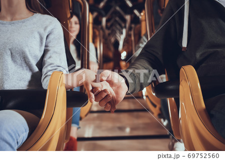 Couple holding hands before ride on roller coaster Couple holding hands before ride on roller coaster 69752560