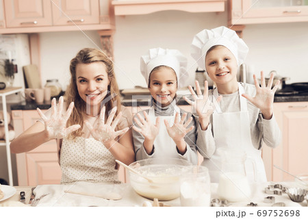 Mom with children looks at the camera.  69752698